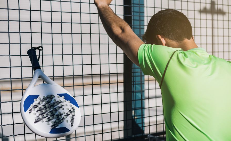 sports man with tennis elbow resting after playing padel tennis